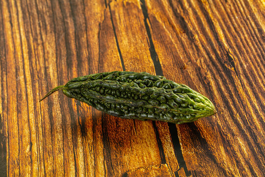 Fresh bitter melon on rustic wooden background