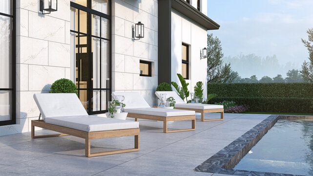 3D rendering of an elegant outdoor relaxation area featuring wooden sun beds with white cushions next to a private swimming pool. Modern house facade with bright tiles and large black-framed windows.