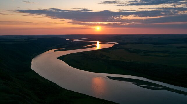 Aerial view of a winding river at sunset, beautiful golden hour landscape with sun reflecting on water