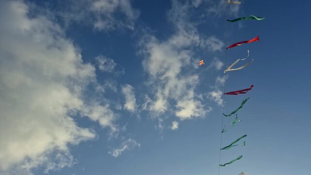 Colorful Kites Flying Against Blue Sky.