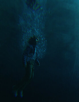 Middle aged man in casual wardrobe under water in ocean. 3D rendered still image.