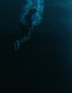 Middle aged man in casual wardrobe under water in ocean. 3D rendered still image.