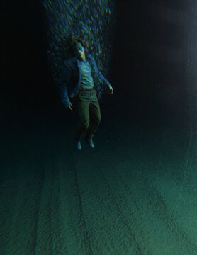 Middle aged man in casual wardrobe under water in ocean. 3D rendered still image.