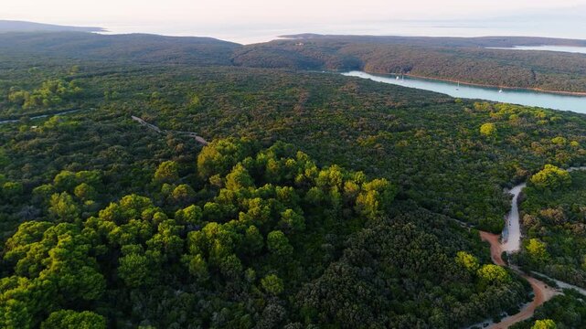 FKK Naturist Baldarin Campsite In Punta Kriza On Cres Island, Croatia, Aerial Drone Shot A Beautiful Summer Evening. Campervans, Motorhomes, Coastal Nature, Crystal Clear Adriatic Sea, Scenic Bays