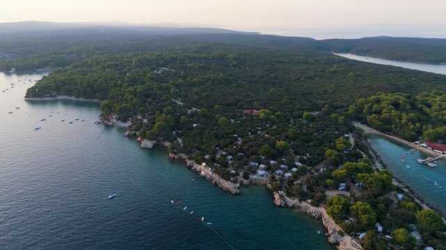 FKK Naturist Baldarin Campsite In Punta Kriza On Cres Island, Croatia, Aerial Drone Shot A Beautiful Summer Evening. Campervans, Motorhomes, Coastal Nature, Crystal Clear Adriatic Sea, Scenic Bays