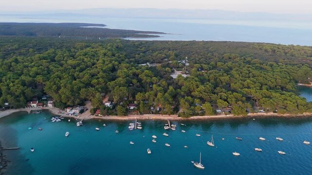 FKK Naturist Baldarin Campsite In Punta Kriza On Cres Island, Croatia, Aerial Drone Shot A Beautiful Summer Evening. Campervans, Motorhomes, Coastal Nature, Crystal Clear Adriatic Sea, Scenic Bays
