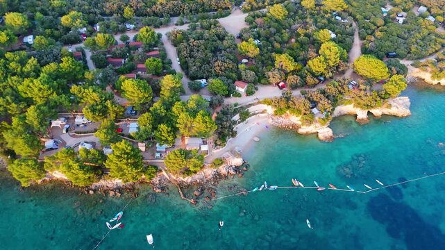 FKK Naturist Baldarin Campsite In Punta Kriza On Cres Island, Croatia, Aerial Drone Shot A Beautiful Summer Evening. Campervans, Motorhomes, Coastal Nature, Crystal Clear Adriatic Sea, Scenic Bays