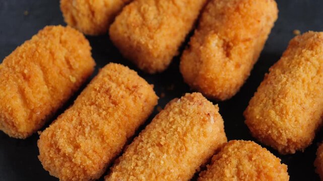 Close-up of Spanish chicken croquettes, a delicate tapas appetizer with a crispy golden coating and creamy filling. High quality 4k footage
