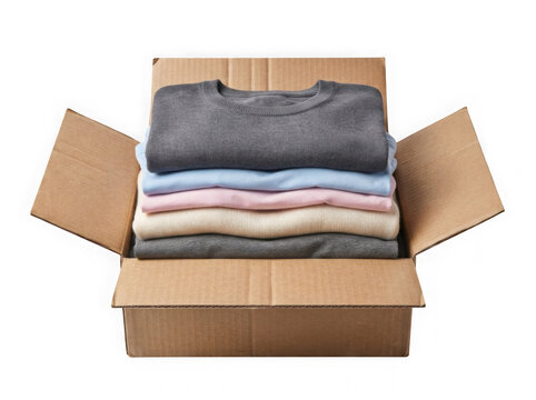 Stack of folded colorful shirts inside an open cardboard delivery box isolated on transparent background