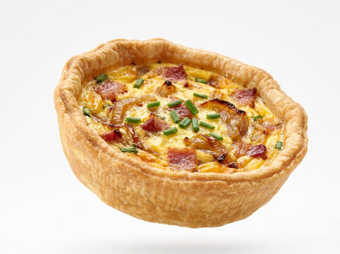 Freshly baked mini quiche lorraine isolated on white background