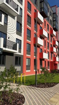 Street at contemporary residential multifamily building. Modern complex of apartment residential condo. Modern residential buildings, apartments in new urban housing. Multifamily residential block.