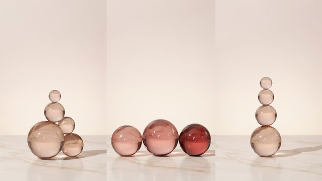 Stacked pink glass spheres and orbs on a marble surface with soft neutral lighting setup