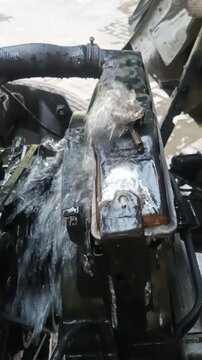 Water gushing out from a broken car radiator leak, mechanical engine breakdown overheating issue