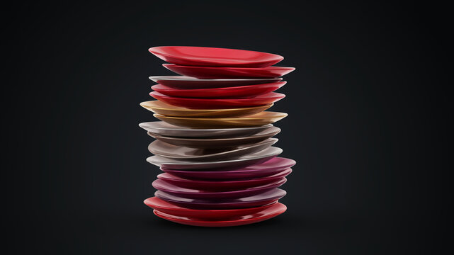 A tall stack of colorful ceramic dinner plates in various shades of red, pink, and beige, neatly arranged on a dark, smooth surface with subtle lighting