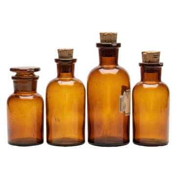 Four amber glass apothecary bottles with cork stoppers