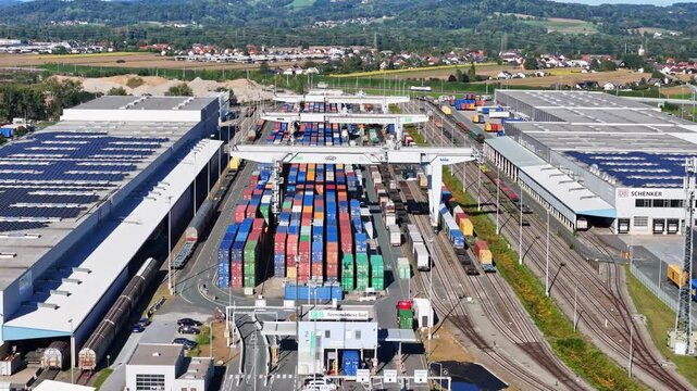 Werndorf, Steiermark, Austria - 21 September 2025: Aerial view of Cargo Center Graz with colorful shipping containers, gantry cranes, and railway tracks in a logistics hub.