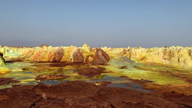 View of the vibrant yellow and red mineral deposits and acidic pools at the Dallol geothermal field in Ethiopia.