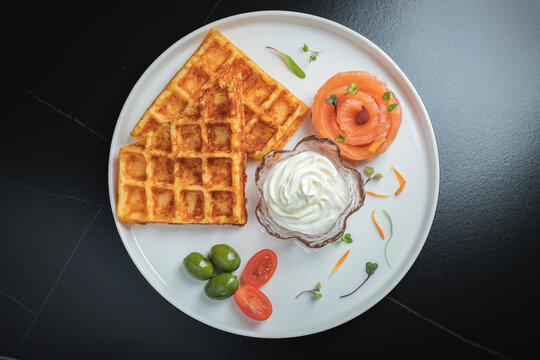 Crunchy waffle fries with sour cream dip served in a basket