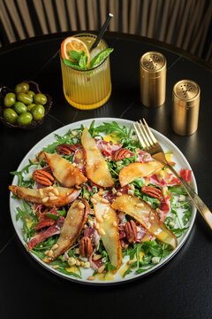 Salad with Pear, Arugula, Jamon, Blue Cheese and Blueberry, Delicious Fresh Salad Appetizer on Bright Background