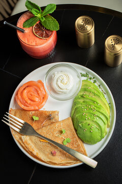 Roasted thin pancakes with smoked salmon and sauce