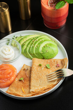Roasted thin pancakes with smoked salmon and sauce