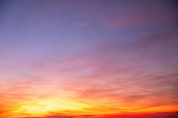 Fototapeta premium Sky sunset,Beautiful sunrise sky with vibrant gradient orange and gold colors and soft blue, Clear atmosphere with wispy clouds. Peaceful, perfect for background and copy space, High resolution images