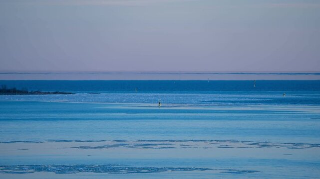 View of Fata Morgana mirage shimmering over the icy waters of the Gulf of Finland. Timelapse. Helsinki, Finland.