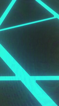 Intersecting glowing blue geometric lines with green accents on dark background animation
