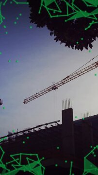 Cranes and building under construction with green geometric animation overlay