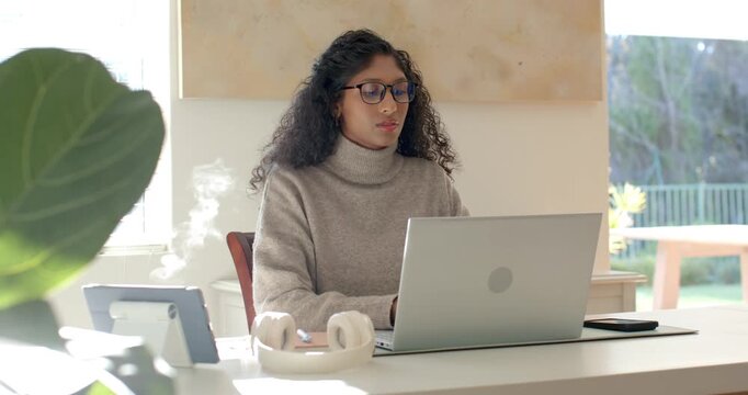 Adult African American woman receiving notification, typing to respond to email on silver laptop