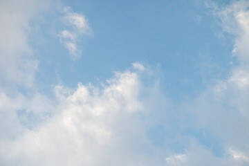Obraz premium Blue sky with soft white clouds. The sky was light blue with soft, slightly translucent white clouds.