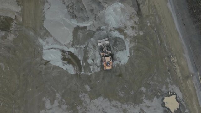 Montrose, Victoria, Australia - 27 August 2026: Aerial view of a front-end loader working at the Boral Montrose quarry with piles of gravel and dirt tracks visible.