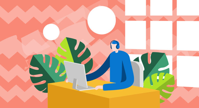 A person wearing headphones works on a laptop at a desk surrounded by tropical plants.