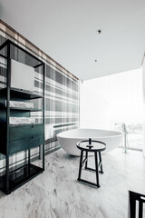 Modern Luxury Hotel Bathroom with Freestanding Tub and City View © CaoVan