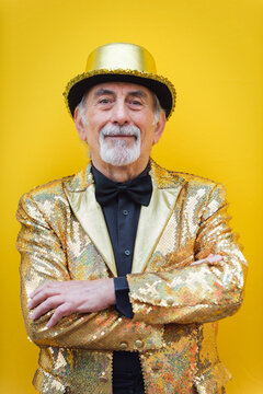 Eccentric senior man portrait - cool and modern old man wearing colorful stylish clothing on colored background