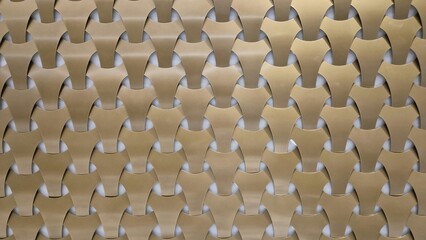 Obraz premium A repeating geometric pattern of interlocking gold and bronze metallic tiles creates a modern, textured, and three-dimensional architectural wall surface.
