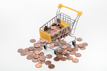 Mini shopping cart with coins on white background © PhamHong