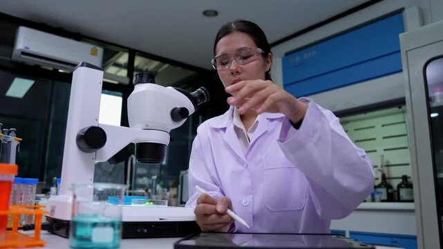 Female scientist conducting experiments in a modern laboratory with advanced technology and equipment