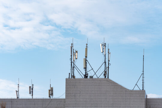 Rooftop cellular antennas and communication masts on urban building