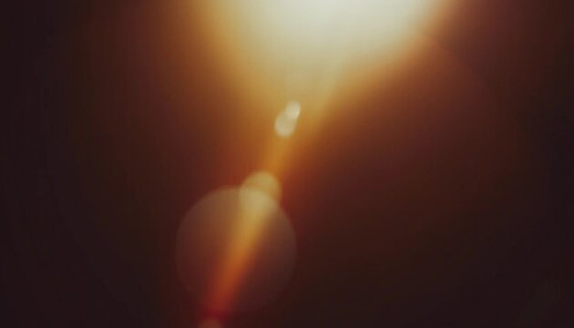 Warm lens flare and light leak background with soft bokeh glow and dark brown tones, cinematic abstract texture for photography, posters, overlays and digital design.