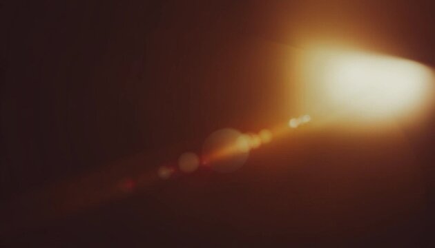 Warm lens flare and light leak background with soft bokeh glow and dark brown tones, cinematic abstract texture for photography, posters, overlays and digital design.