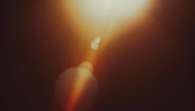 Warm lens flare and light leak background with soft bokeh glow and dark brown tones, cinematic abstract texture for photography, posters, overlays and digital design.
