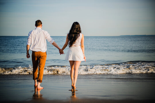 young couple walking on the beach