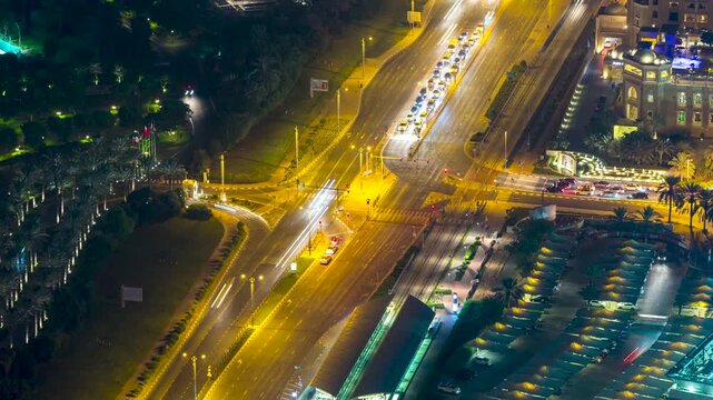 View of nighttime traffic at a busy intersection with light trails from vehicles in the city center of Dubai, Dubai, United Arab Emirates.