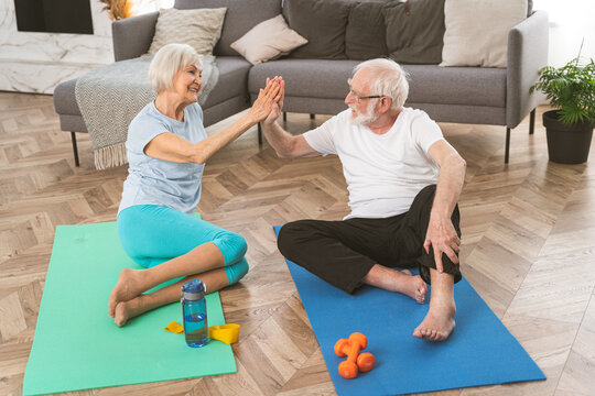 Elderly couple doing fitness training together at home 