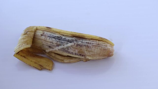 Peeled Rotten Banana Showing Spoiled Internal Pulp on White Background - Food Waste, Fruit Decay, and Quality Control Concept