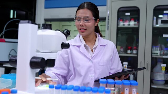 Woman scientist conducting microbiology experiments using cutting edge technology in a modern laboratory environment