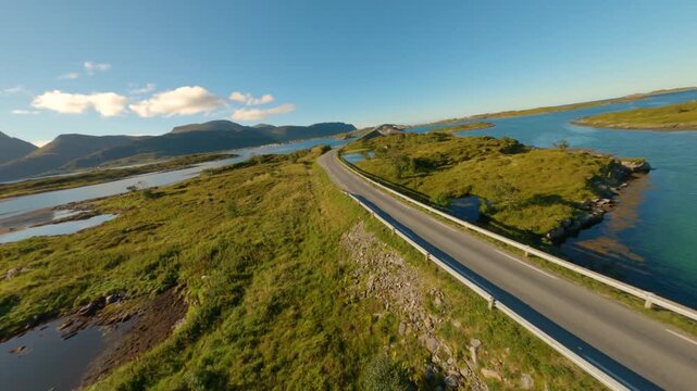 FPV aerial view of the road winding through the islands of Lofoten in Nordland, Norway.
