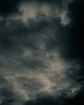 Dark storm clouds gather across a moody sky, creating a powerful atmospheric background ideal for weather, climate, cinematic concepts and dramatic environmental designs.