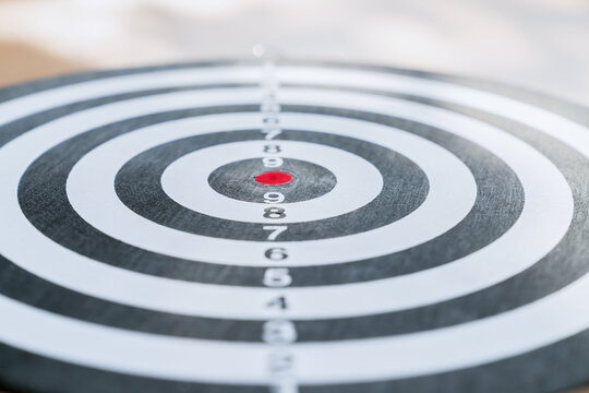 Dartboard and get someone skilled to throw darts, concept for business target planning growth and aim to winner goal.